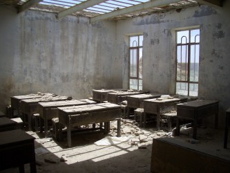 The scale of the challenge: an empty school room in Garmsir. The school was closed due to insecurity, and its corridor and exterior are pock-marked from fighting between the insurgents and the Afghan and international military. The school re-opened in September and is being refurbished and equipped by the UK.