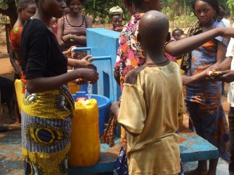 Locals gather around the water point