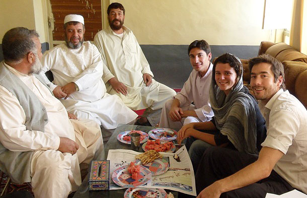 Photo of Tim and a colleague having diner with some Afghanistan locals