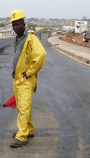 Photo of a man standing on a road