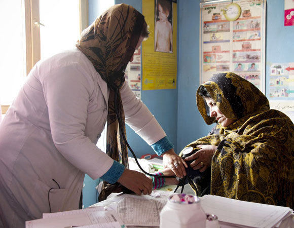Photo of a nurse taking a woman's blood pressure