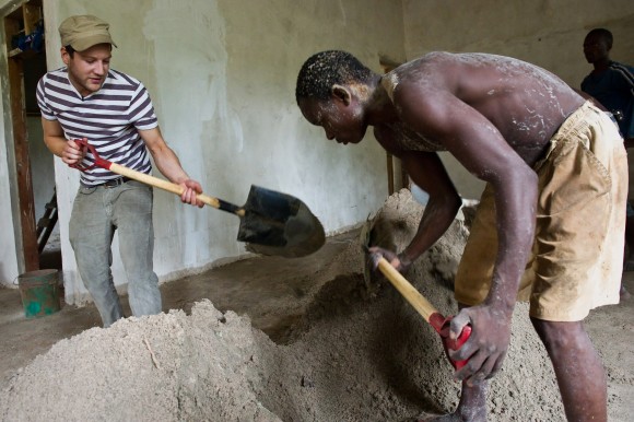 Digging in: helping to shovel cement with a worker building a new health clinic in Tanzania. Picture: Jonathan Banks/Comic Relief