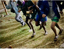 Children race to school for morning lessons. Picture: Chris de Bode/Panos