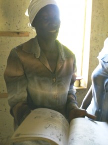 A teacher holds open a book