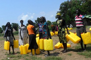 Over 100 women arrive with Jerry cans to collect water for families and people with disabilities in the local community. Picture: Ian Hughes/FCO