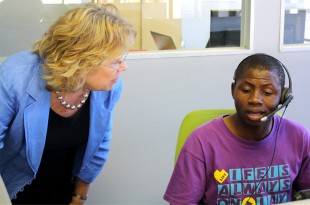 Baroness Northover speaks to a member of staff at LoveLife's new call centre. Picture: Julia Smith/DFID