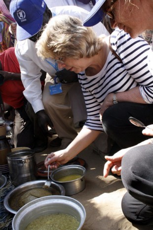 Baroness Northover tastes some of the sample dishes prepared by the women. Picture: Vicky Seymour/DFID