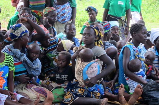 Young women and their children watch women community leaders act out short plays. The young mother with the twins is on the extreme right. Picture: Baroness Northover/DFID