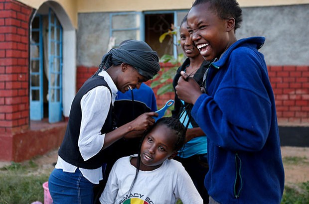 Eunice, 13, helps braid the hair of another resident at Samburu Girls Foundation. The girls are most vulnerable to FGM and forced marriage during the school holiday breaks. Picture: Newsha Tavakolian/Too Young to Wed/The Girl Generation